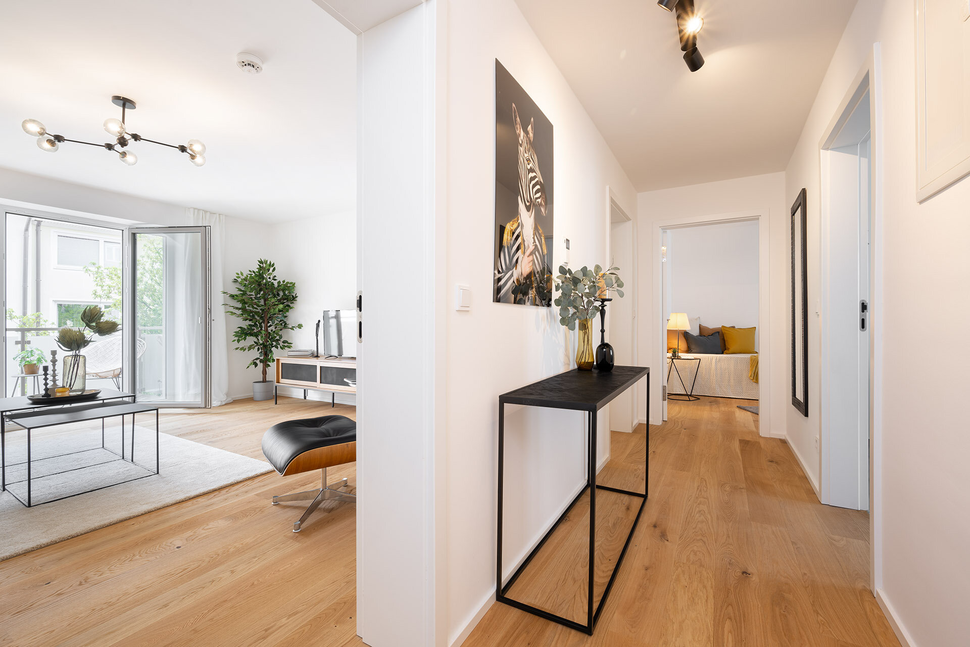Flur und Wohnzimmeransicht in minimalistischem Einrichtungsstil